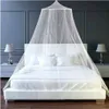 A white mosquito net canopy is draped over a white bed in a bedroom. Náhled obrázku produktu