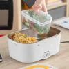 A person is placing a container of salad into an electric lunch box. Produktbild-Vorschau