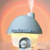 A blue mushroom-shaped humidifier with a small mushroom figurine inside a cutout, emitting mist. The background features a sunset-like gradient. Produktbild-Vorschau