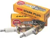 Two boxes of NGK spark plugs are stacked, with three spark plugs in the foreground. Náhled obrázku produktu