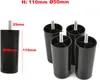 A set of four black plastic furniture legs with metal threaded bolts, shown on a white background. Dimensions are indicated on one of the legs. Voir les images du produit