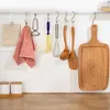 Kitchen utensils hanging on a rack above a countertop. Produktbild-Vorschau