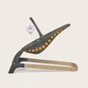 A baby bouncer with a wooden base and a gray seat with orange dots, shown from the side against a light gray background. A small toy star hangs from a mobile arm. Produktbild-Vorschau