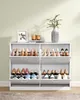 A white shoe cabinet filled with shoes, placed against a light green wall. Náhled obrázku produktu