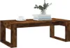 A wooden coffee table with a cup of coffee and books on it. Voir les images du produit