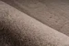 A close-up view of a rolled-up taupe rug. Produktbild-Vorschau