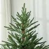 Close-up view of the top section of a green artificial Christmas tree. Podgląd zdjęcia produktu