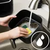 Hands washing the basket of an air fryer under a faucet. Produktbild-Vorschau