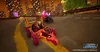 A video game screenshot showing characters racing karts in a city at dusk. Podgląd zdjęcia produktu
