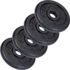 Four black weight plates stacked diagonally against a white background. Produktbild-Vorschau