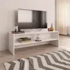 A white TV stand with a television and decorative items on it, placed in a living room setting with a rug in the foreground. Náhled obrázku produktu