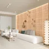 A modern living room with a light brown wooden wall paneling and a white sectional sofa. Produktbild-Vorschau