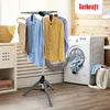 A laundry room scene with a clothes drying rack, washing machine, and laundry basket. Voir les images du produit