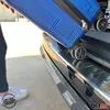 A person is loading a blue suitcase into the trunk of a car. Produktbild-Vorschau