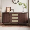 A wooden sideboard with rattan drawer fronts and doors, decorated with framed pictures and a vase of greenery, placed in a room. Podgląd zdjęcia produktu