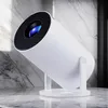 A white projector is displayed on a marble surface with a marble wall in the background. Náhled obrázku produktu