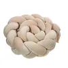 A braided pillow or bed bumper is shown against a white background. Produktbild-Vorschau