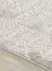 A close-up view of a rug with a detailed pattern. Voir les images du produit
