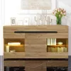 A modern wooden sideboard with LED lighting, displaying decorative items and books. Produktbild-Vorschau