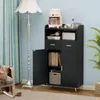 A black storage cabinet with two doors and two drawers, placed in a room with a blue wall and a floor lamp. Anteprima dell’immagine prodotto
