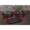 A set of cookware, including two frying pans and a griddle, is displayed on a dark countertop with a textured gray wall in the background. A small potted plant is visible behind the pans. Anteprima dell’immagine prodotto