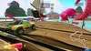 A racing game scene with a yellow pickup truck on a wooden track, with a large pink octopus and a ship in the background. Produktbild-Vorschau