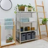 A bathroom or laundry room setting with a metal shelving unit, a towel rack, and a ladder. Podgląd zdjęcia produktu