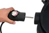 A hand is holding a black electric grill temperature control unit and is about to insert it into a black grill. Produktbild-Vorschau