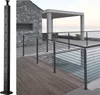 A modern outdoor deck with a cable railing system around a swimming pool, with a stone house in the background. Náhled obrázku produktu