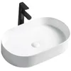 A white oval countertop sink with a black faucet against a white background. Náhľad obrázku produktu