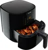 A black Philips air fryer with chicken drumsticks inside the basket. Produktbild-Vorschau