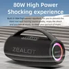 A black portable speaker with a handle and colorful lights on the side, placed on a textured surface with a blurred background of striped lines. Náhled obrázku produktu