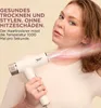 A woman is using a white Shark hair dryer on her hair, with pink and white air effects emanating from the dryer. Text is overlaid on the left side of the image. Voir les images du produit
