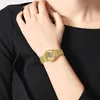 A person wearing a gold digital watch on their wrist. Produktbild-Vorschau