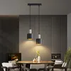 A dining room setting with a table and chairs, illuminated by two pendant lights. Produktbild-Vorschau
