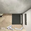 A bathroom scene showing a shower tray, drain, and flexible pipe. Produktbild-Vorschau