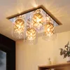 A modern ceiling light fixture with multiple glass shades and crystal accents, mounted on a ceiling. Podgląd zdjęcia produktu