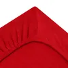 A close-up view of a red fitted sheet, showing the elasticized corner. Produktbild-Vorschau