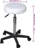 A white adjustable stool with a black base and wheels, shown against a white background with dimensions indicated. Náhled obrázku produktu