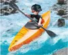 A toy figure in a kayak on a river. Anteprima dell’immagine prodotto