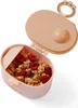 A pink baby food container filled with granola and berries, with the lid open. Produktbild-Vorschau