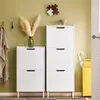 A hallway with two white shoe cabinets, a blanket hanging on a hook, and a yellow umbrella stand. Náhľad obrázku produktu