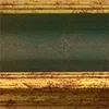 A close-up view of a picture frame's decorative border, showing the textured green and gold finish. Produktbild-Vorschau