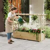 A woman is watering plants in a wooden raised garden bed with a trellis structure. Náhled obrázku produktu