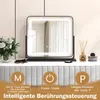A makeup mirror with integrated lighting is displayed on a vanity table, with decorative items and cosmetics nearby. The bottom of the image features graphical elements and text explaining the mirror's features. Produktbild-Vorschau