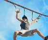 A young person is using a slackline ninja line set outdoors. Produktbild-Vorschau