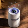 A white cylindrical air purifier with blue light is placed on a wooden table, with bubbles floating above it. Náhled obrázku produktu