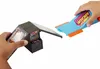 Two hands holding parts of a toy arcade track set. Produktbild-Vorschau