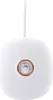 A white, pebble-shaped digital alarm clock with a rose gold ring around a small, clear window containing a white cat figurine. Podgląd zdjęcia produktu