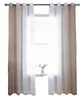 A window with curtains and a small plant on the windowsill. Produktbild-Vorschau